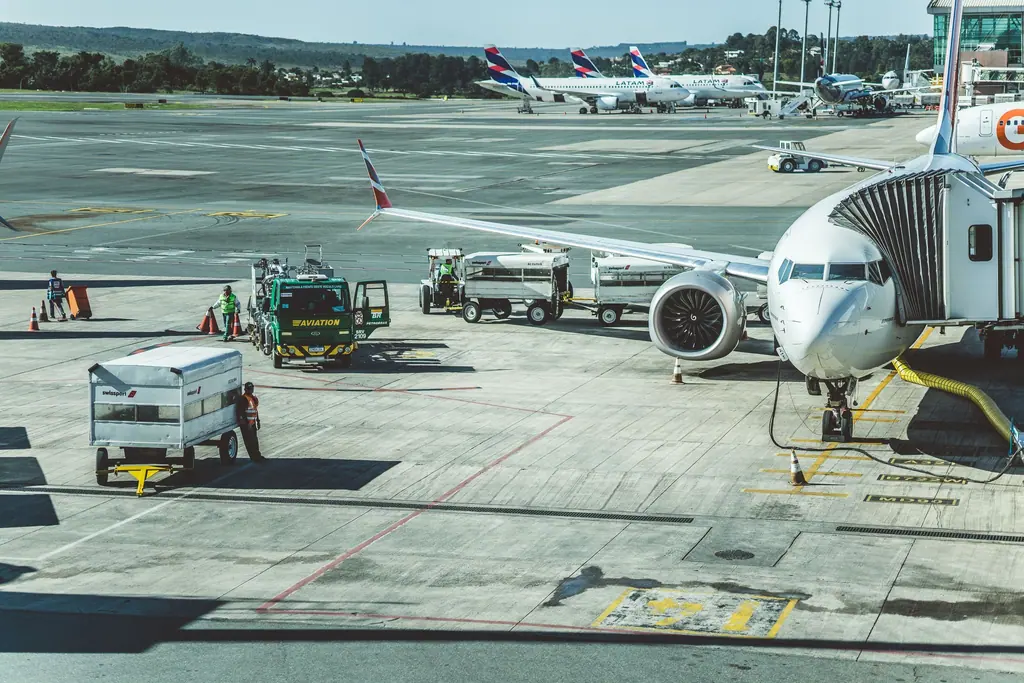 Ground handling equipment beside a freighter at an airport stand